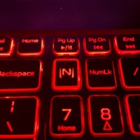 a close up of a keyboard with red lights on it